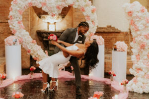 man dipping woman after proposing in Houston